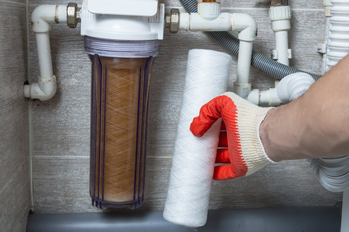 Technician replacing a water filter cartridge